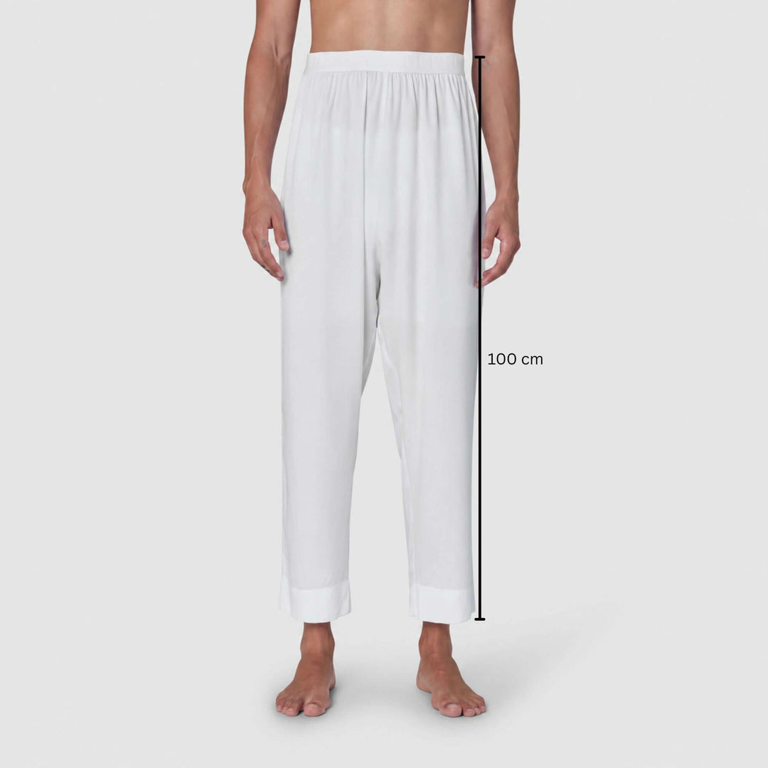 White relaxed-fit pants shown on a model from the waist down against a light gray background, with a vertical measurement marker indicating 100 cm length.
